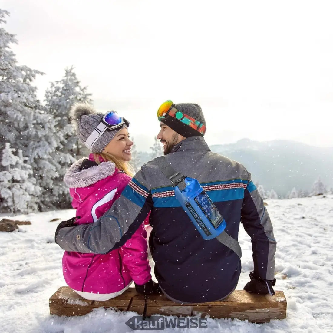 Paar in Winterkleidung sitzt auf verschneitem Berg mit Celly Explorer Dry Bag 2L